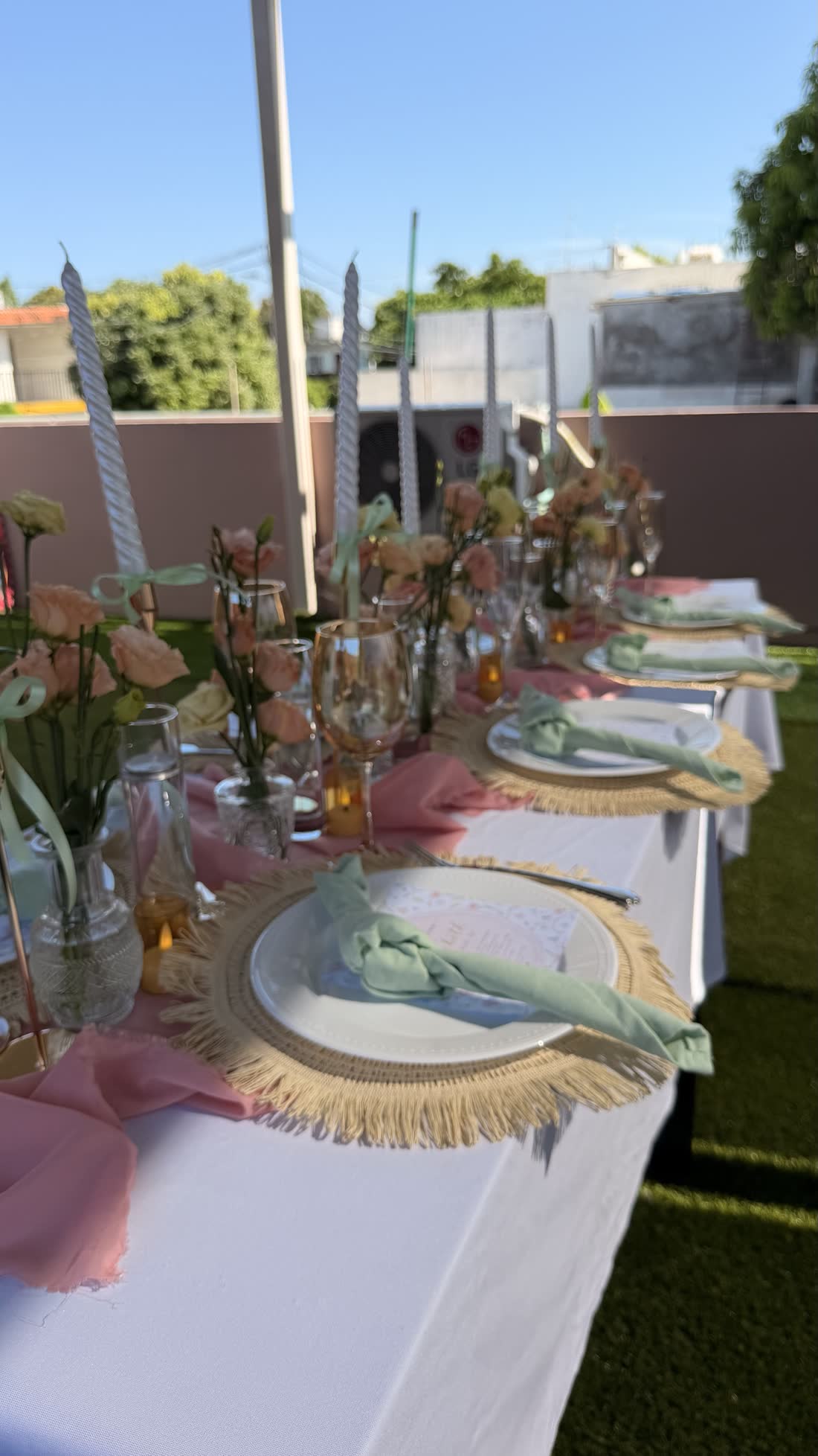 Detalle de mesa en tonos pastel con cristalería, flores suaves y montaje decorativo de ETERIA.
